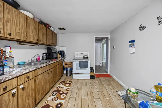 a kitchen with stainless steel appliances granite countertop a refrigerator and wooden cabinets