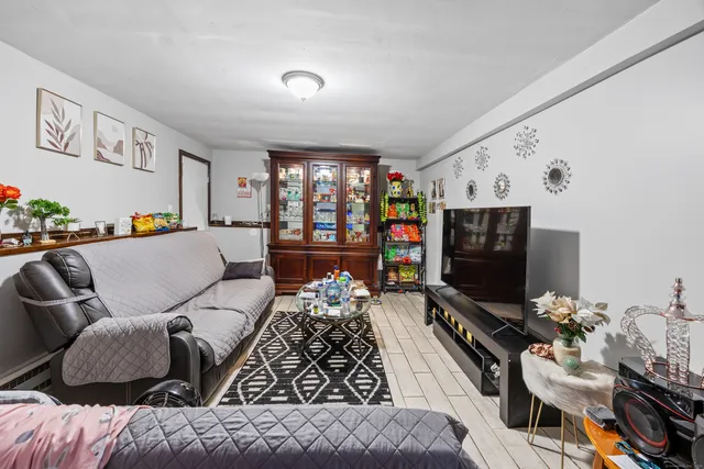 a living room with furniture a window and a flat screen tv