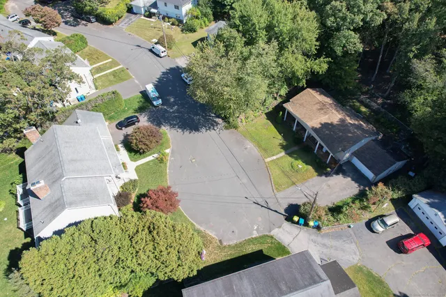 an aerial view of a house with a yard and garden