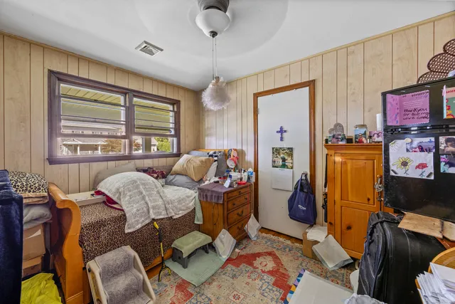 a bedroom with furniture and a window