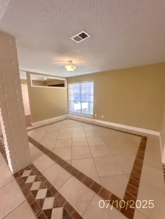 a view of an empty room with glass door