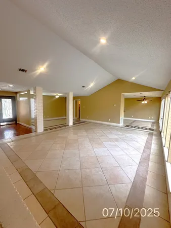 a kitchen with granite countertop a sink cabinets and stainless steel appliances