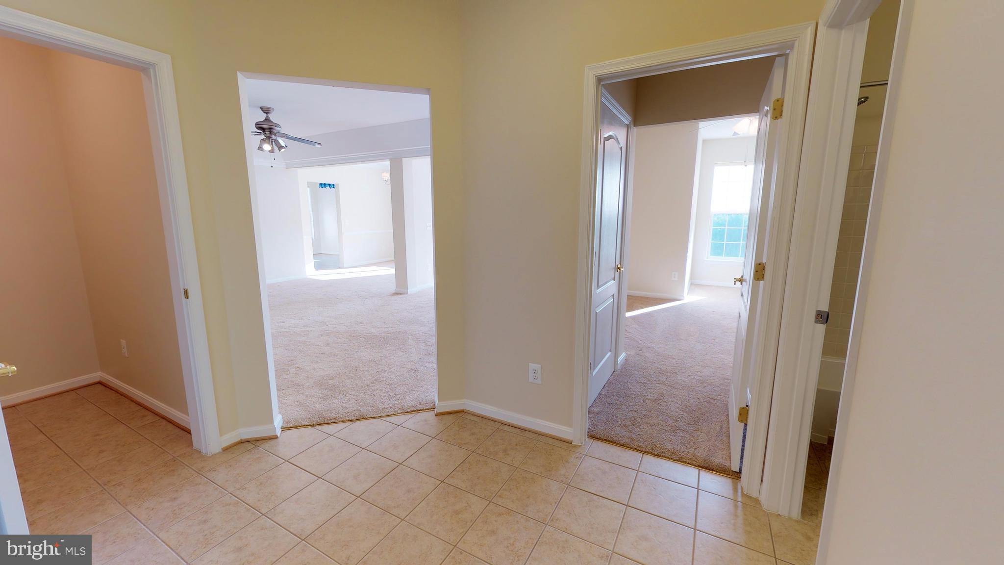 8601 Roaming Ridge Way, Unit 402 Odenton, MD 21113 - Photo 2 of 30 an empty room with mirror