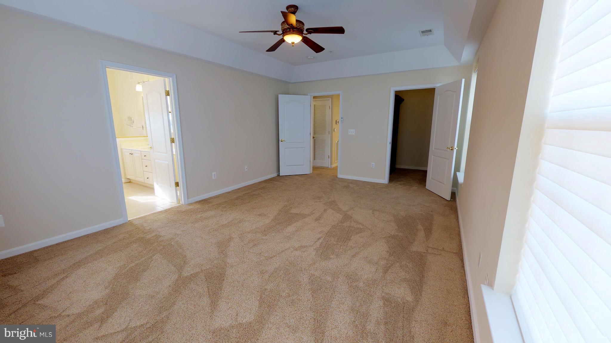 8601 Roaming Ridge Way, Unit 402 Odenton, MD 21113 - Photo 12 of 30 a view of empty room with ceiling fan