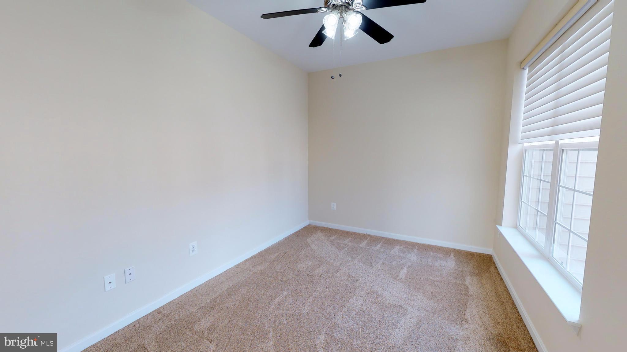 8601 Roaming Ridge Way, Unit 402 Odenton, MD 21113 - Photo 17 of 30 an empty room with a window