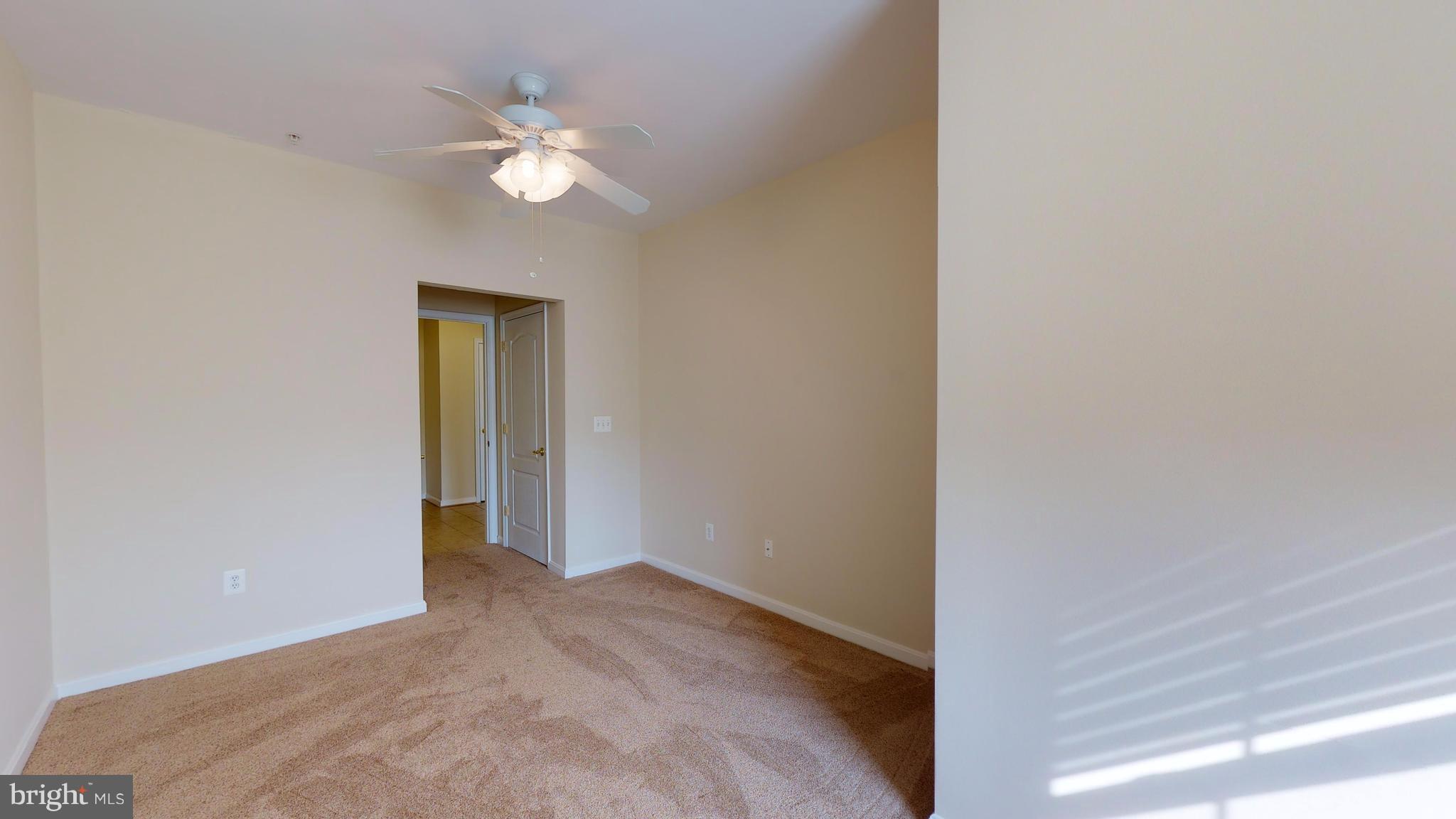 8601 Roaming Ridge Way, Unit 402 Odenton, MD 21113 - Photo 20 of 30 a view of a livingroom with a chandelier fan