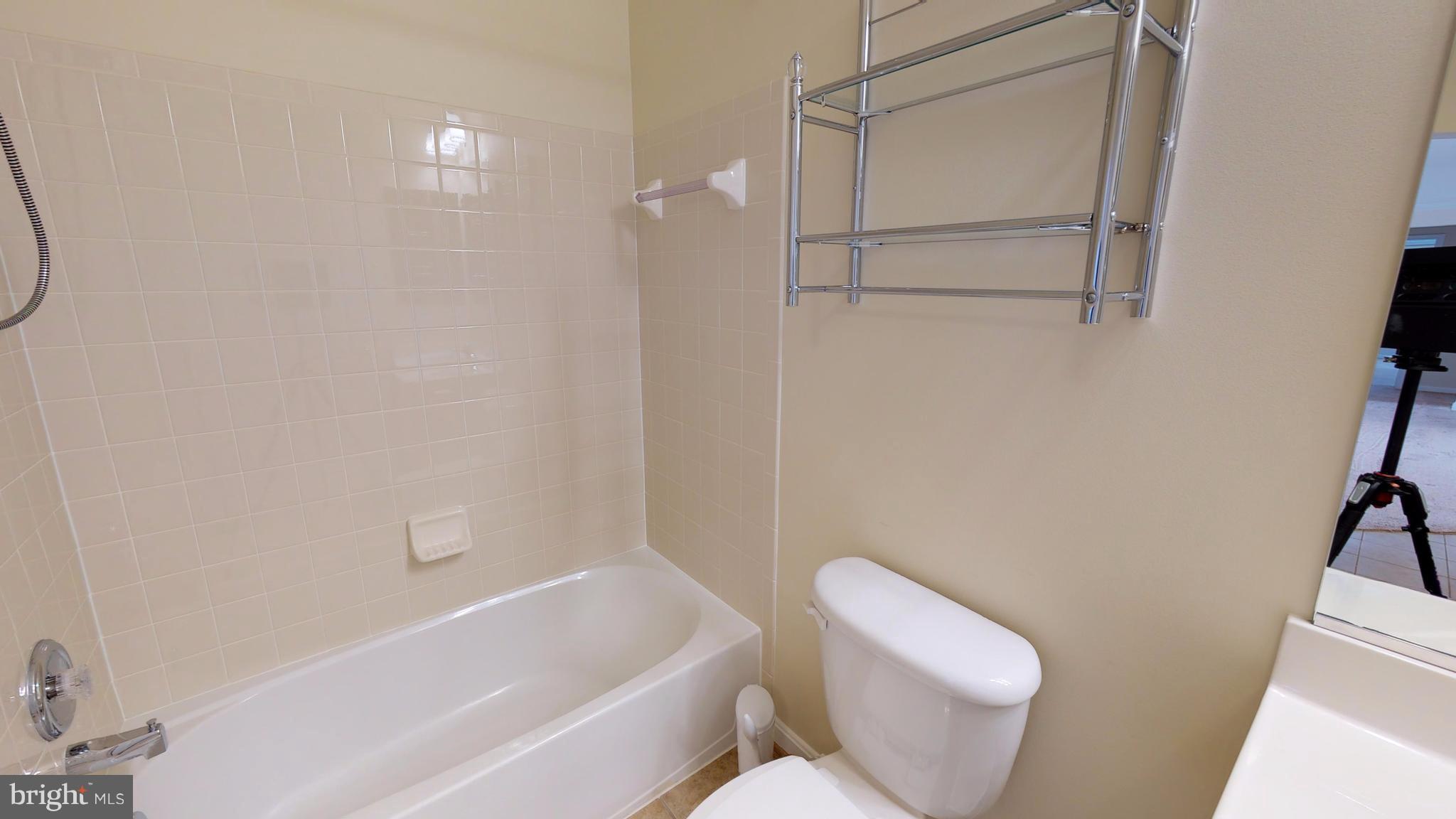 8601 Roaming Ridge Way, Unit 402 Odenton, MD 21113 - Photo 21 of 30 a bathroom with a toilet and a bathtub