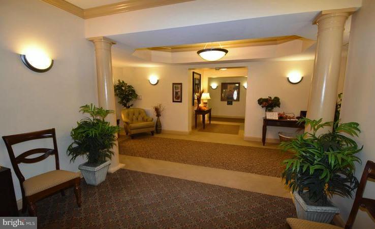 8601 Roaming Ridge Way, Unit 402 Odenton, MD 21113 - Photo 24 of 30 a lobby with furniture and potted plant