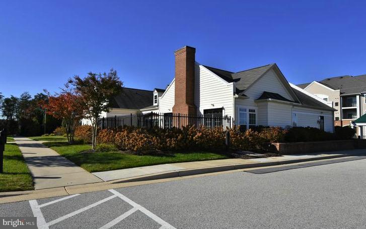 8601 Roaming Ridge Way, Unit 402 Odenton, MD 21113 - Photo 25 of 30 a front view of a house with a yard