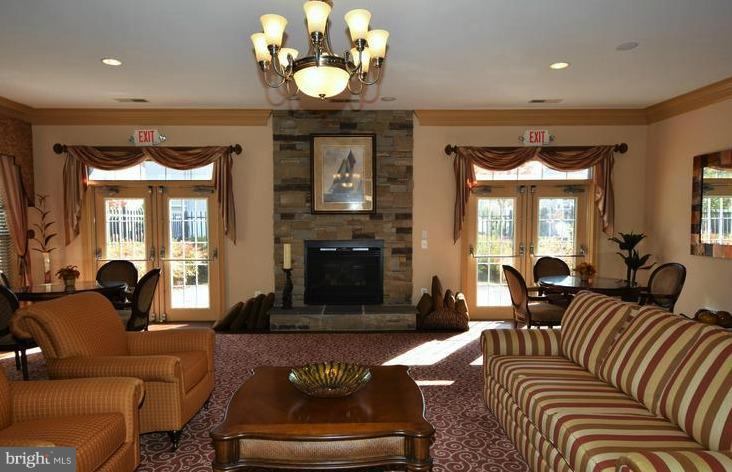 8601 Roaming Ridge Way, Unit 402 Odenton, MD 21113 - Photo 26 of 30 a living room with furniture and a large window