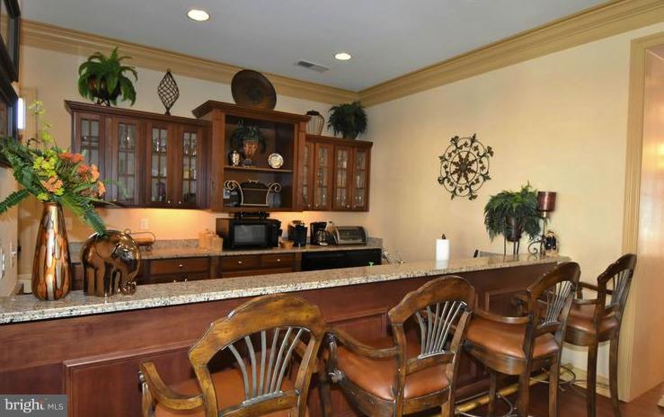 8601 Roaming Ridge Way, Unit 402 Odenton, MD 21113 - Photo 27 of 30 a kitchen with a table and chairs in it
