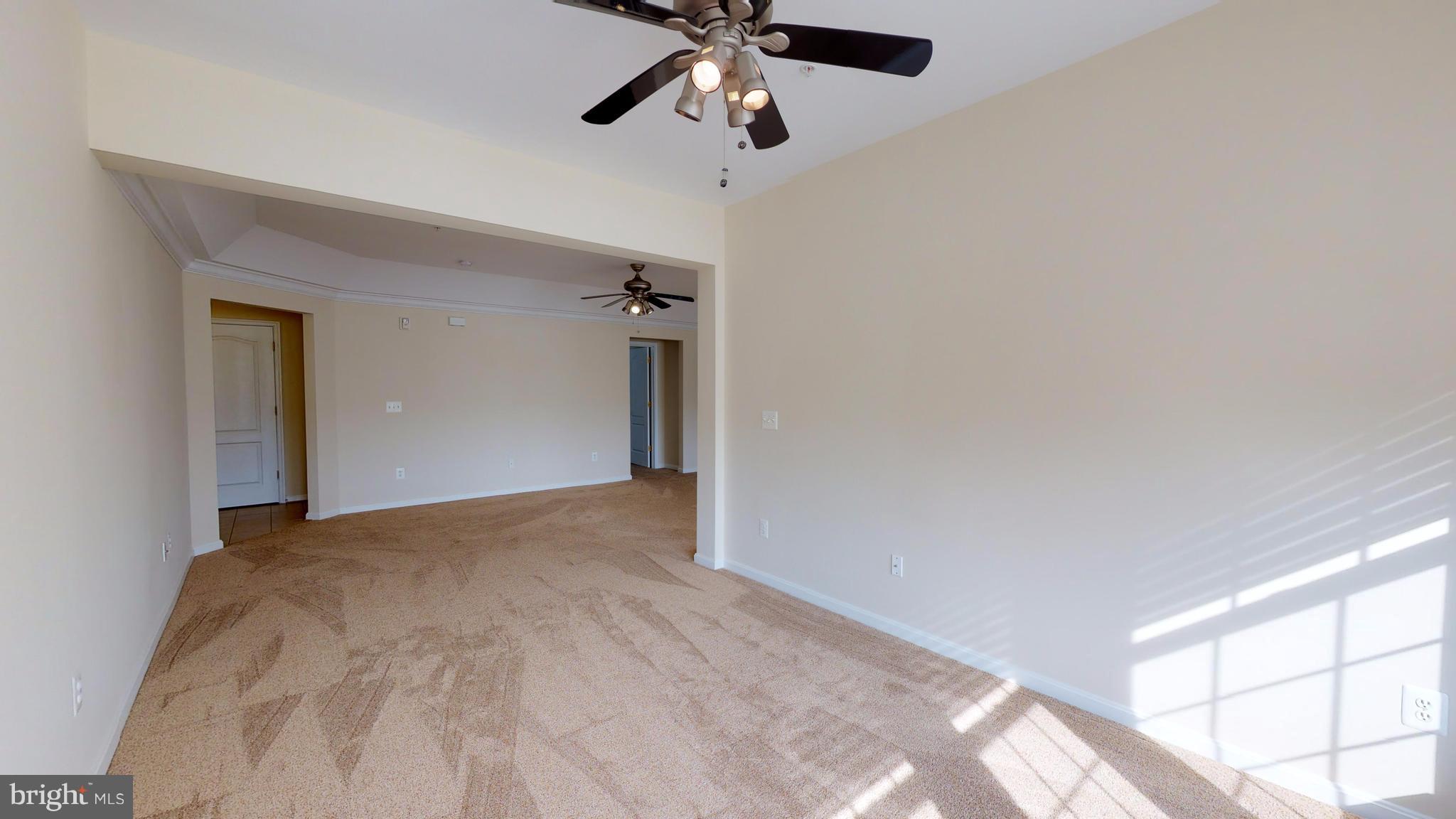 8601 Roaming Ridge Way, Unit 402 Odenton, MD 21113 - Photo 5 of 30 a view of empty room with a ceiling fan