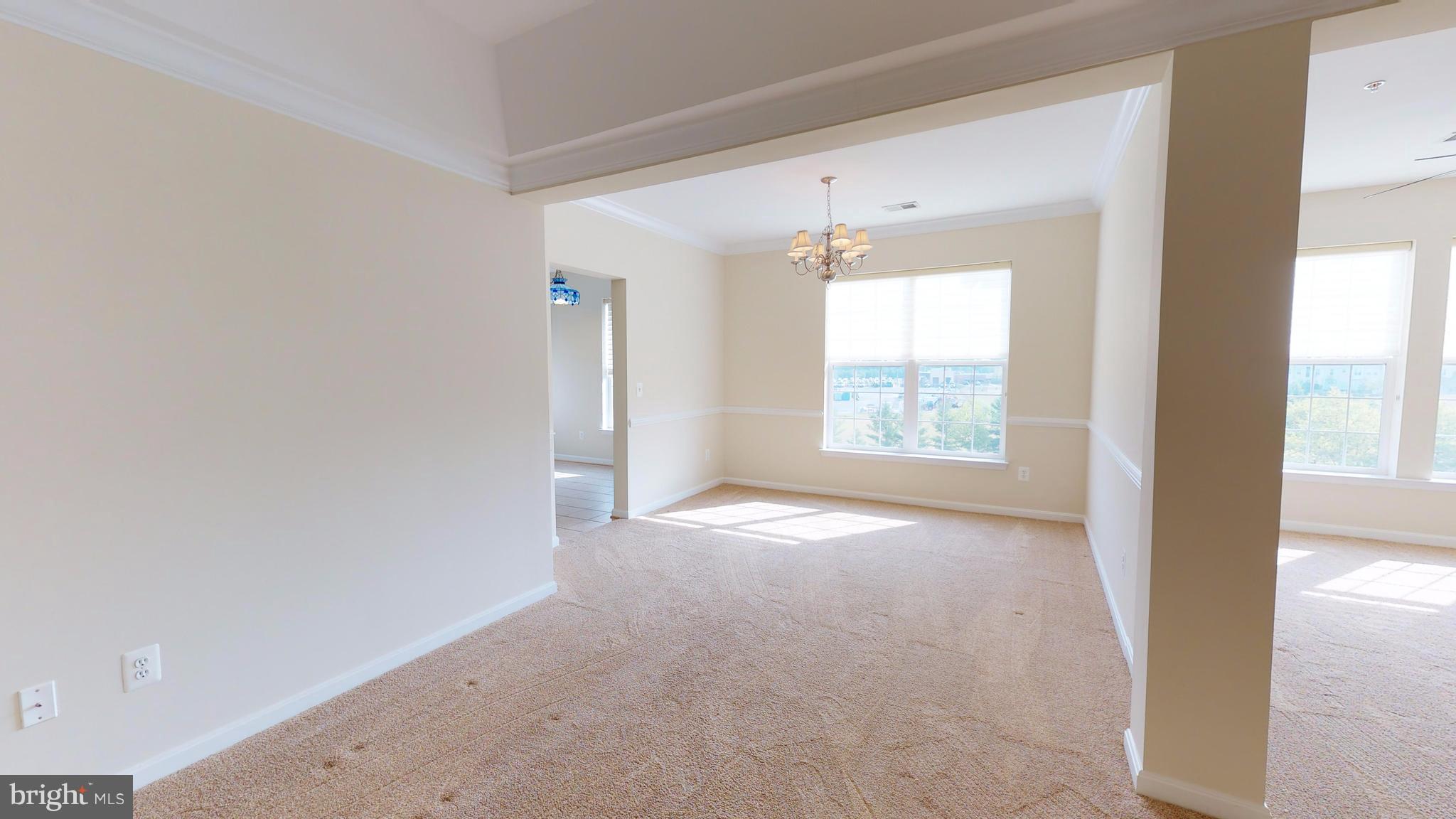 8601 Roaming Ridge Way, Unit 402 Odenton, MD 21113 - Photo 6 of 30 an empty room with windows and outdoor view
