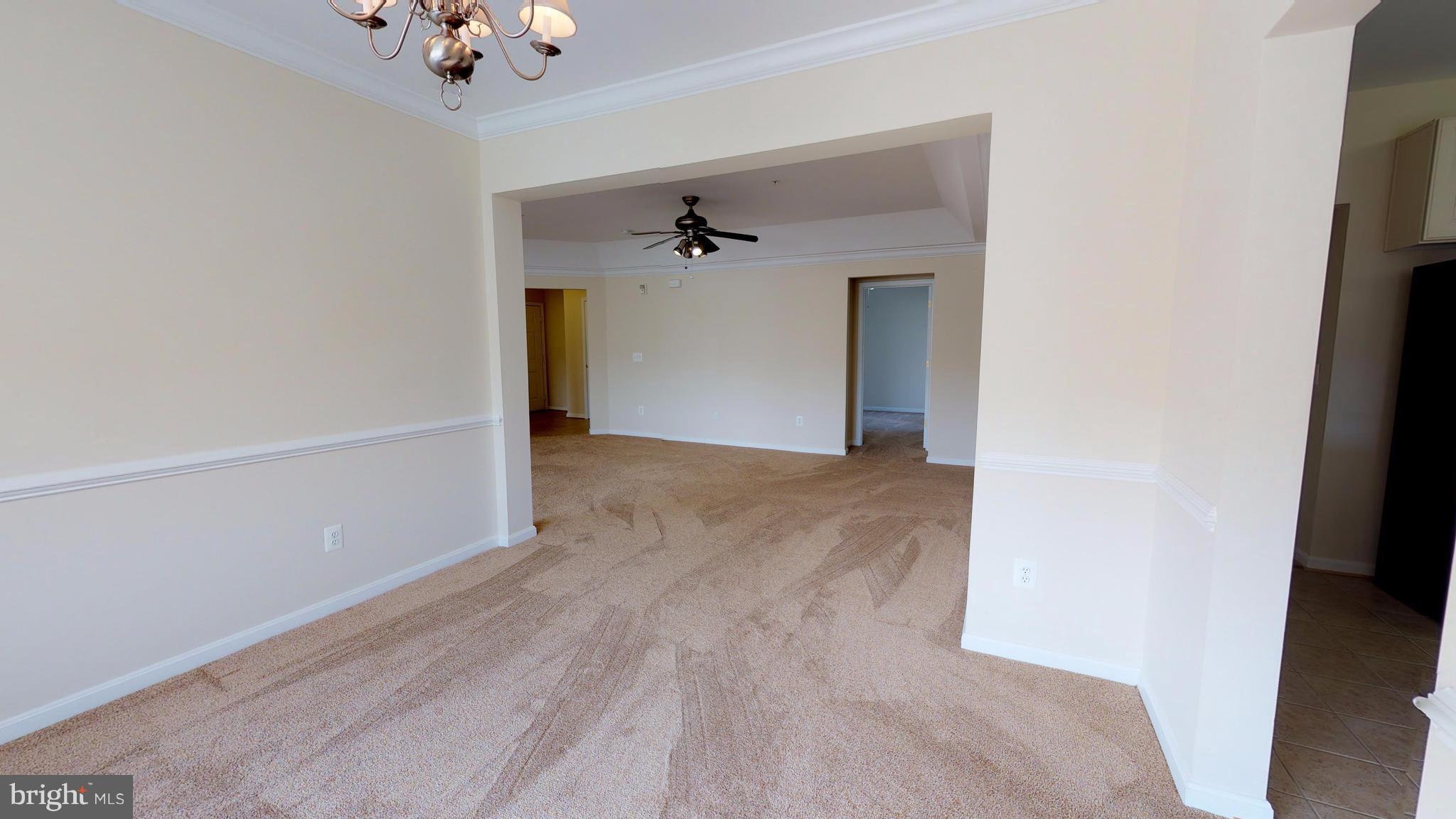 8601 Roaming Ridge Way, Unit 402 Odenton, MD 21113 - Photo 7 of 30 wooden floor in an empty room with a window