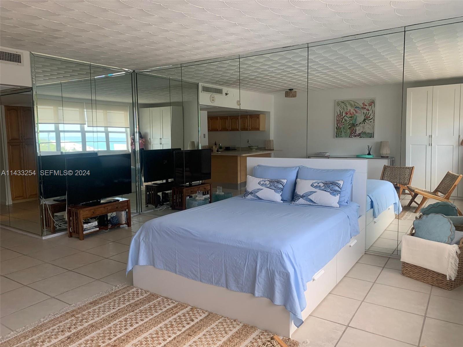 100 Lincoln Road, Unit 1039 Miami Beach, FL 33139 - Photo 12 of 26 a bedroom with a bed and a flat screen tv
