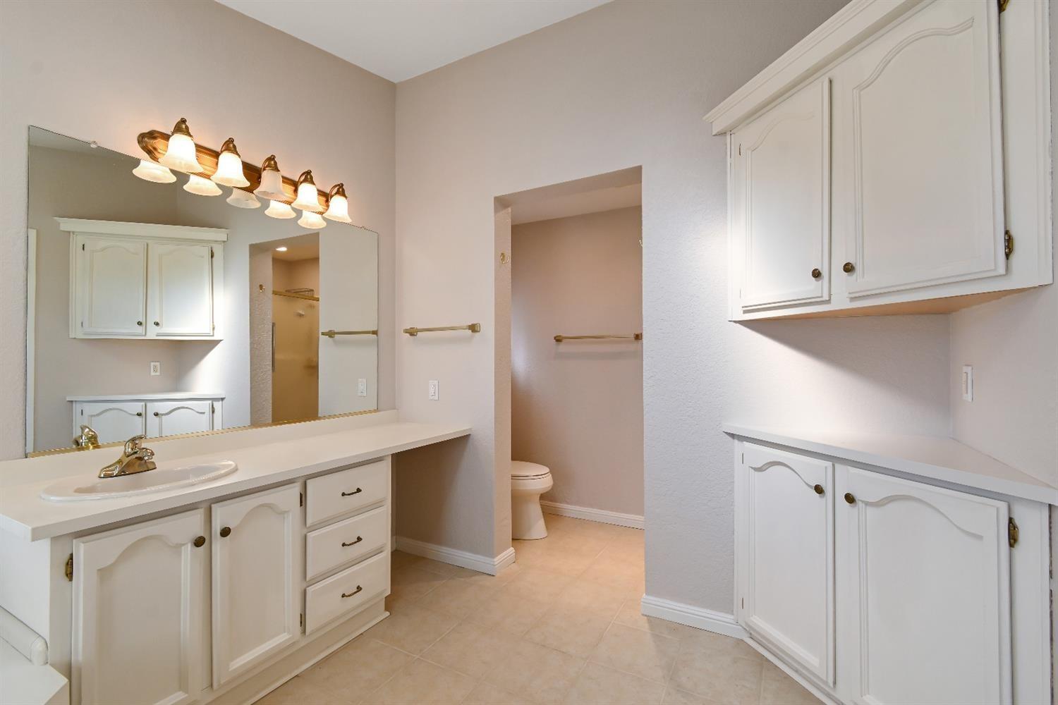 15655 County Road 45 Guinda, CA 95637 - Photo 15 of 66 a bathroom with a double vanity sink a mirror and a bathtub