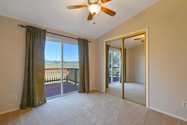 a view of a kitchen with a sink cabinet a ceiling fan and wooden floor