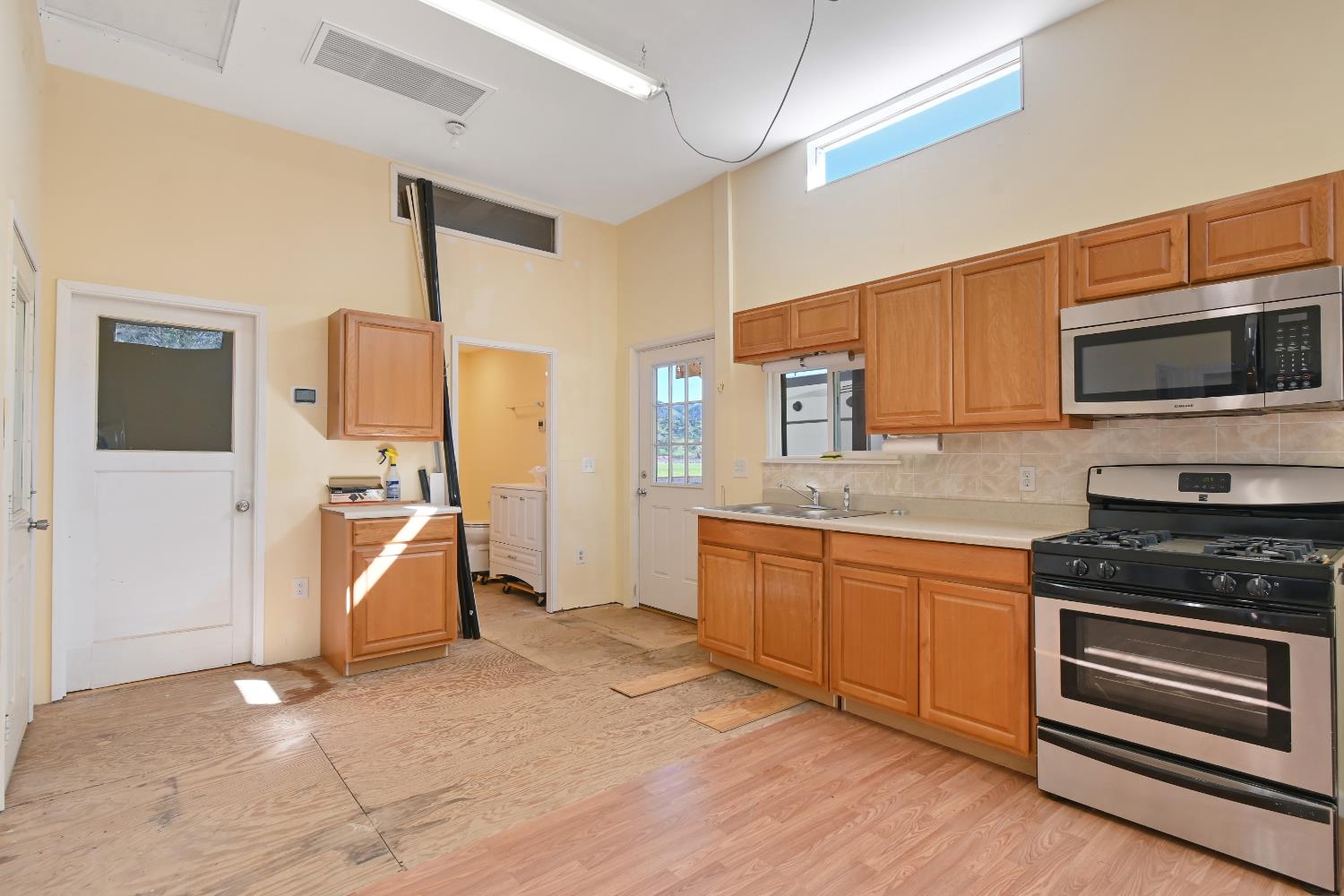 15655 County Road 45 Guinda, CA 95637 - Photo 43 of 66 a kitchen with granite countertop a stove a sink and a microwave oven