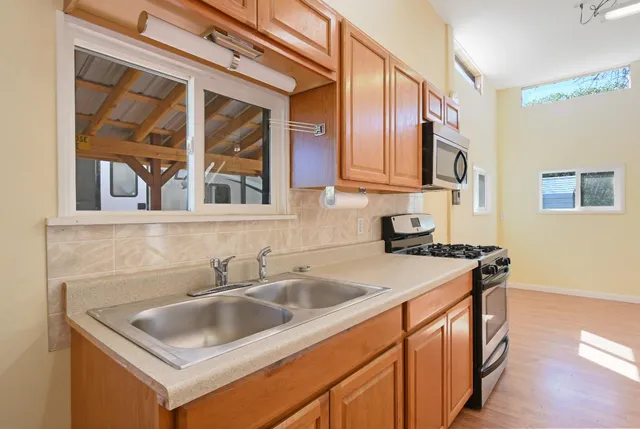 a yellow house sitting in middle of the grass