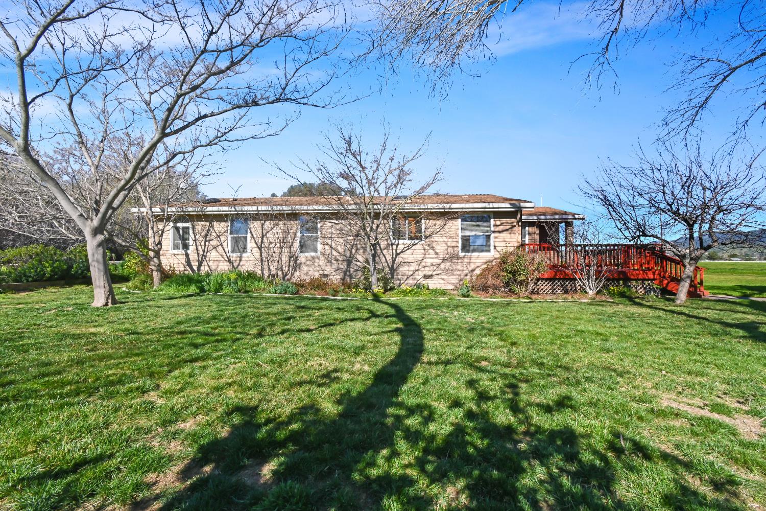 15655 County Road 45 Guinda, CA 95637 - Photo 63 of 66 a front view of a house with a garden and trees