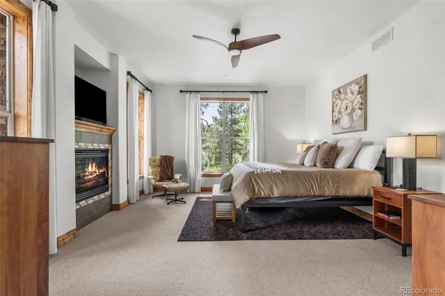 a bedroom with a bed a couch and a window