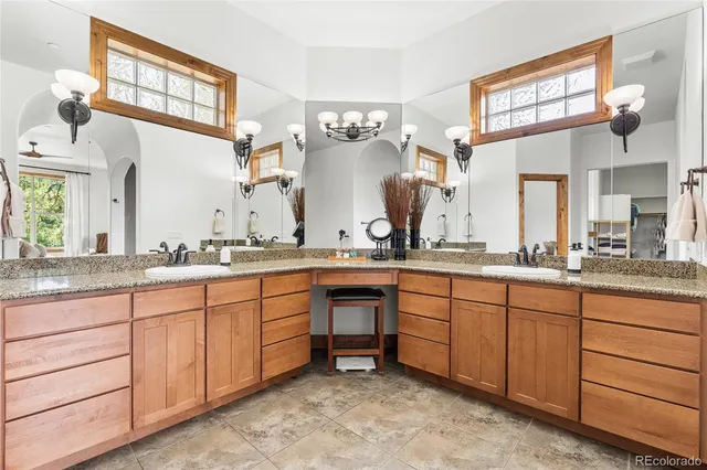 a spacious bathroom with sink and mirror