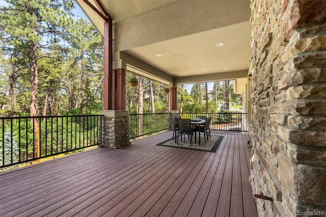 a view of a porch with wooden floor and furniture
