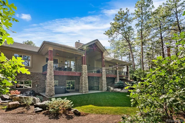 a view of a chair and table in the backyard