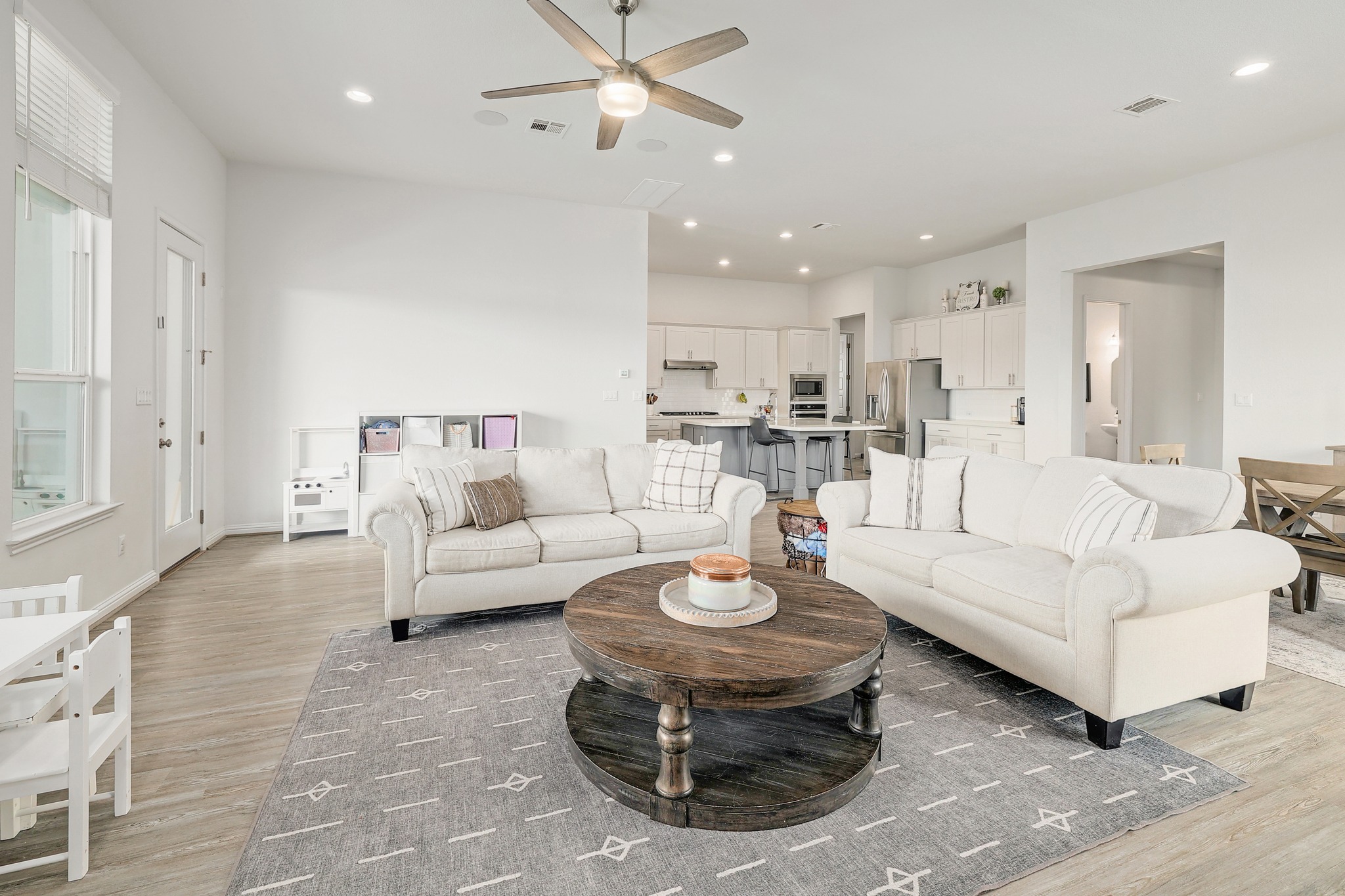 108 Argo Cove Georgetown, TX 78628 - Photo 7 of 36 Living room with a ceiling fan, recessed lighting, and light wood-style flooring