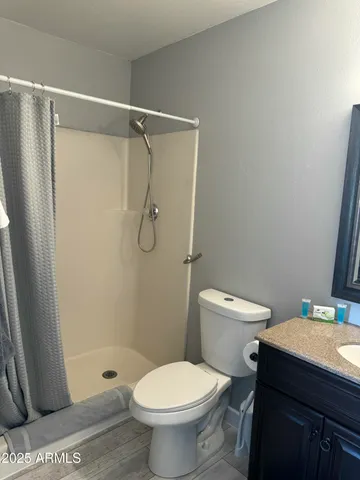 a bathroom with a toilet a sink and shower