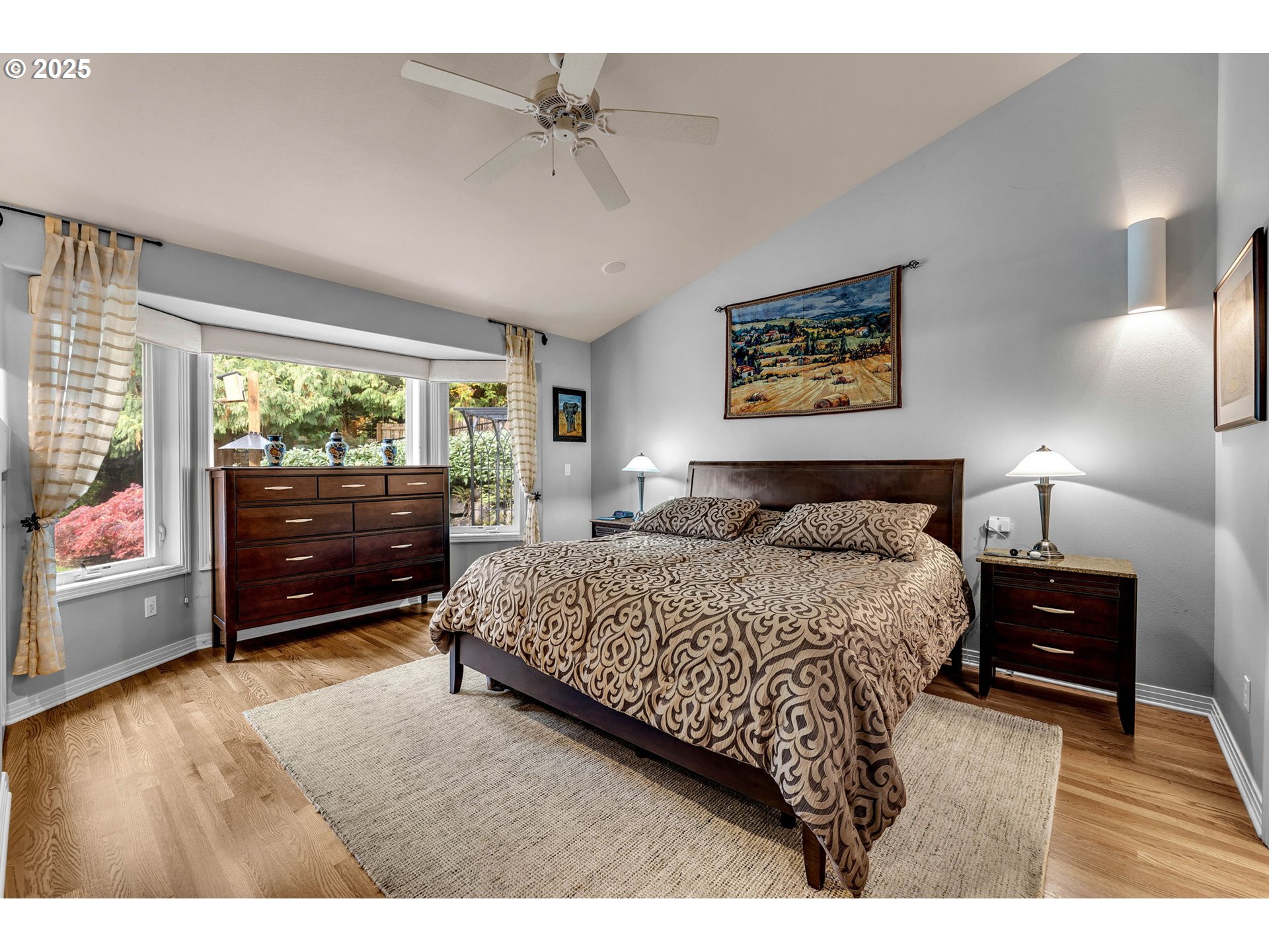 3496 Chaparrel Loop West Linn, OR 97068 - Photo 18 of 41 a spacious bedroom with a bed a dresser and a large window