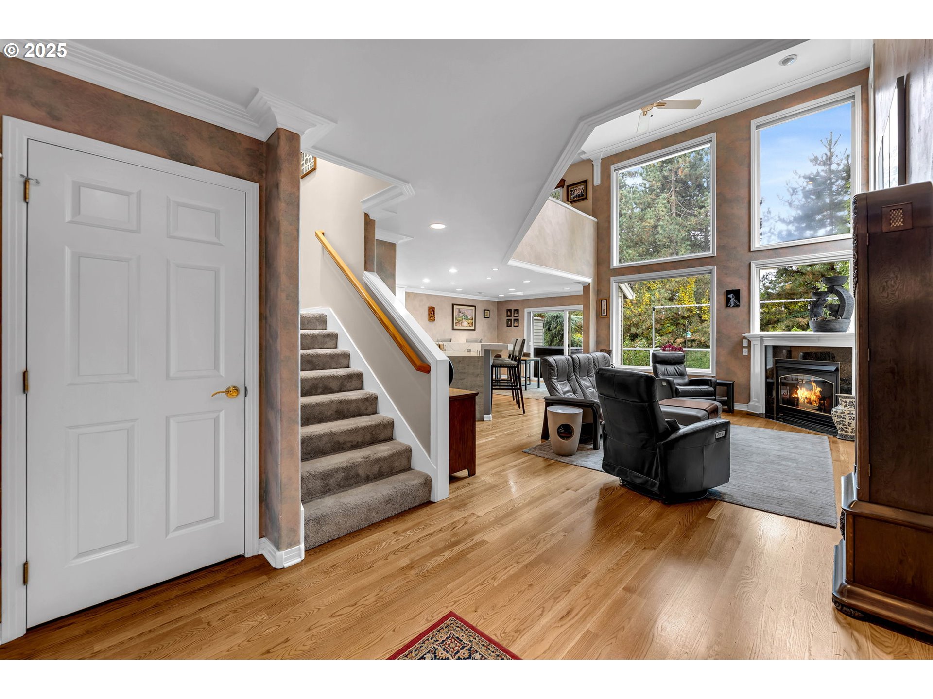 3496 Chaparrel Loop West Linn, OR 97068 - Photo 5 of 41 a living room with furniture floor to ceiling window and wooden floor