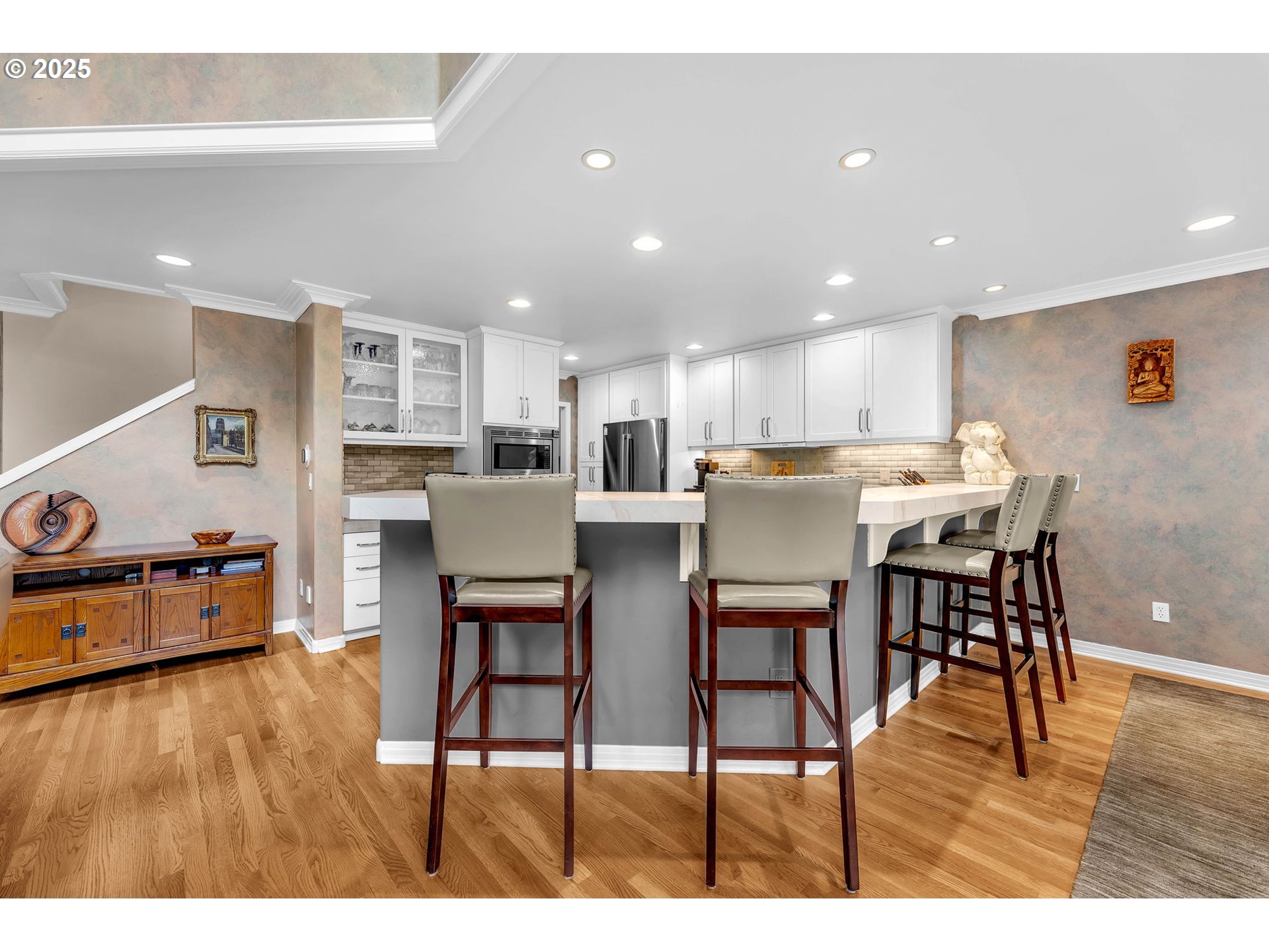 3496 Chaparrel Loop West Linn, OR 97068 - Photo 10 of 41 a kitchen with stainless steel appliances kitchen island granite countertop a table chairs and a refrigerator