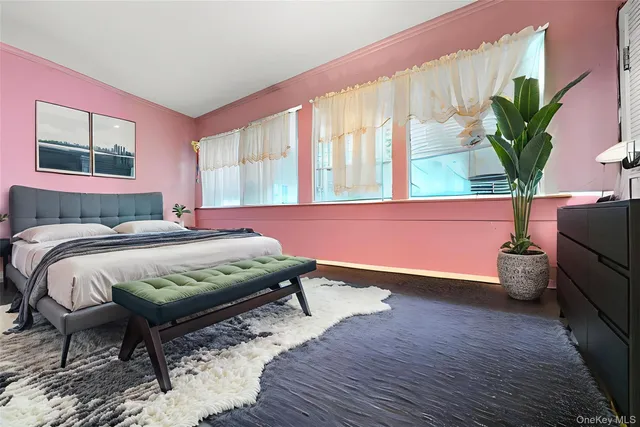 a bedroom with a bed and a potted plant
