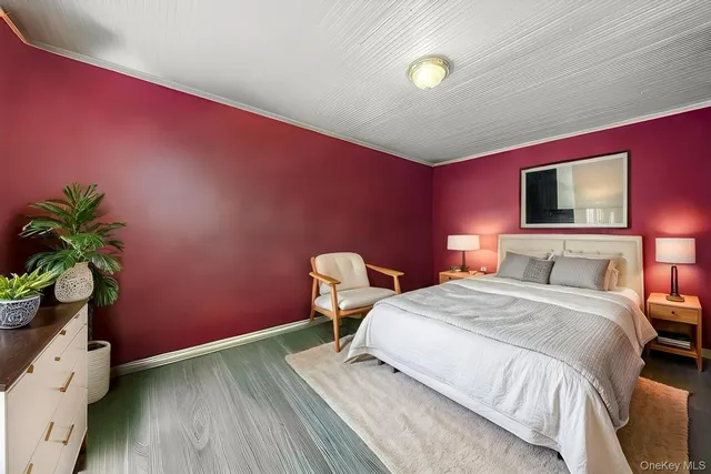 a bedroom with a bed and a potted plant