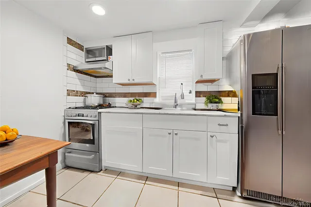 a kitchen with cabinets and appliances