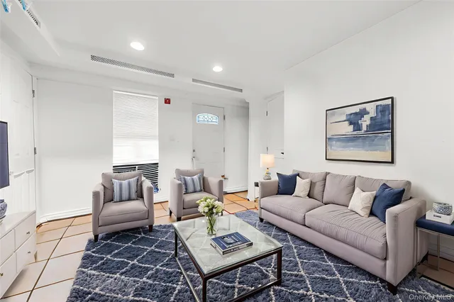 a living room with furniture and a rug