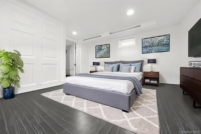 a spacious bedroom with a bed and a couch