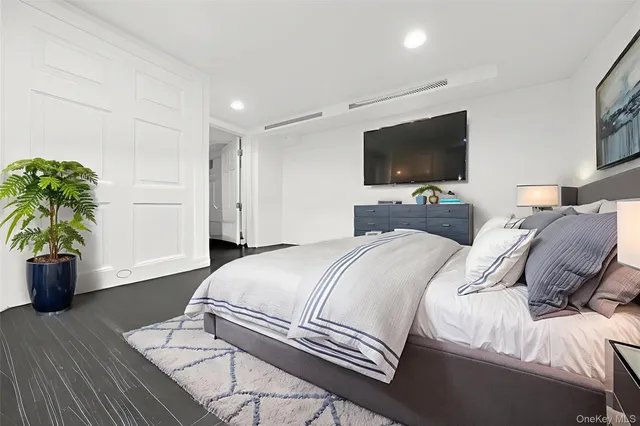 a bedroom with a bed and a television