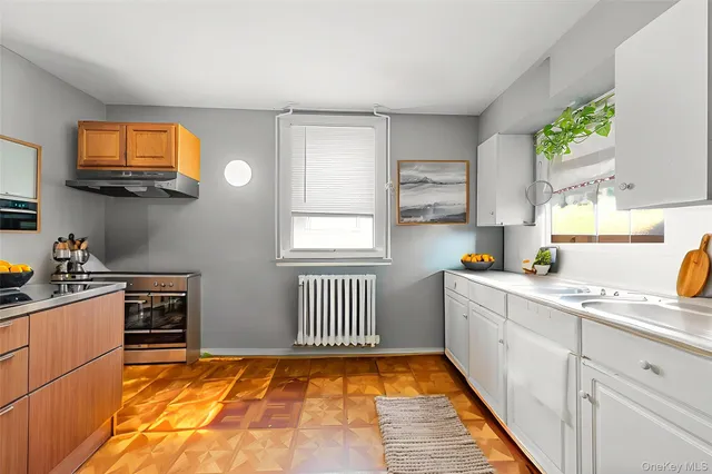 a kitchen with stainless steel appliances a sink stove and cabinets