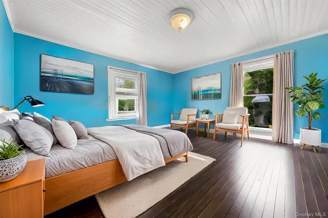 a bedroom with bed couch and window