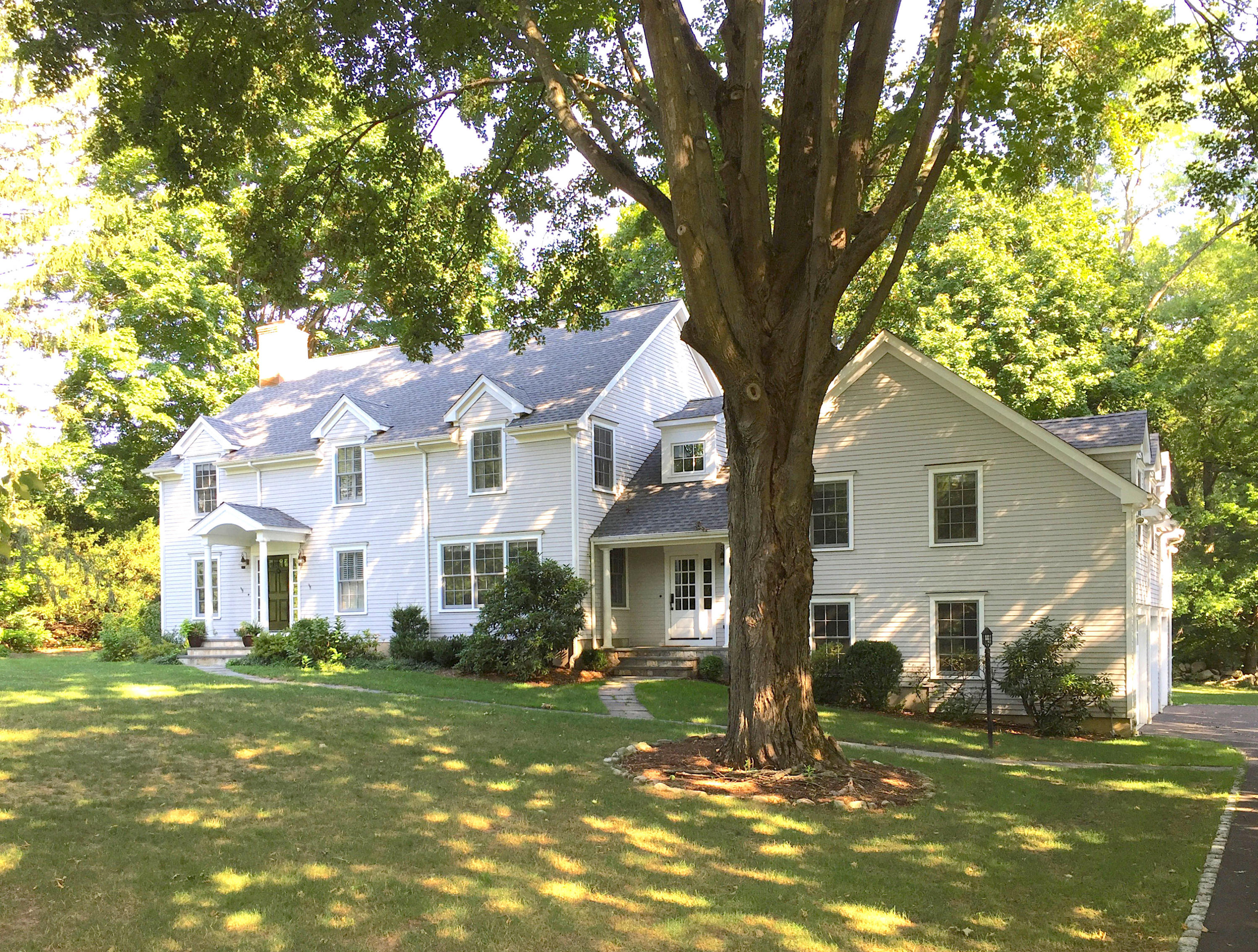 181 Middlesex Road Darien, CT 06820 - Photo 2 of 38 a view of a white house next to a yard with a large tree