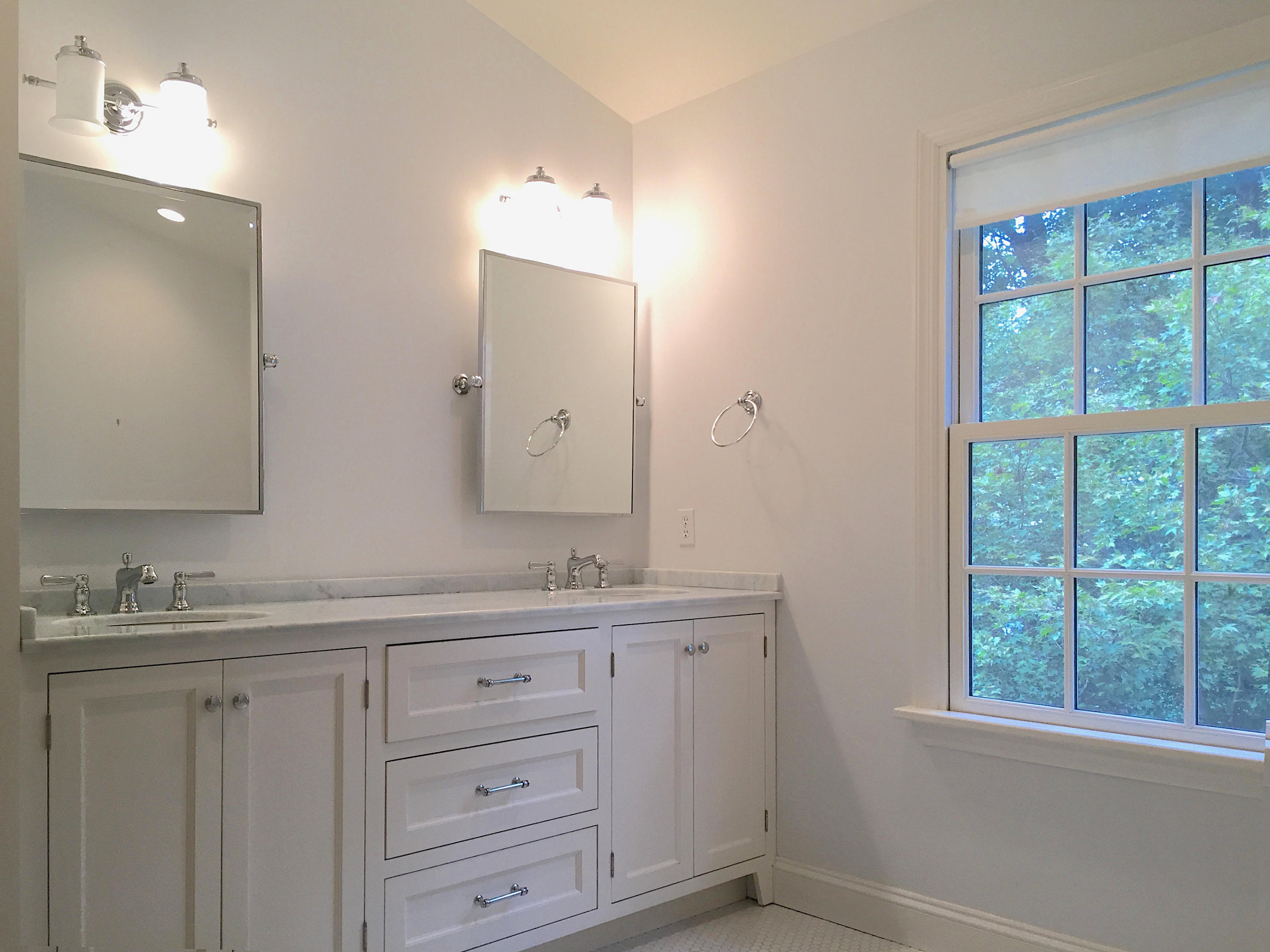 181 Middlesex Road Darien, CT 06820 - Photo 28 of 38 a bathroom with a double vanity sink and a mirror