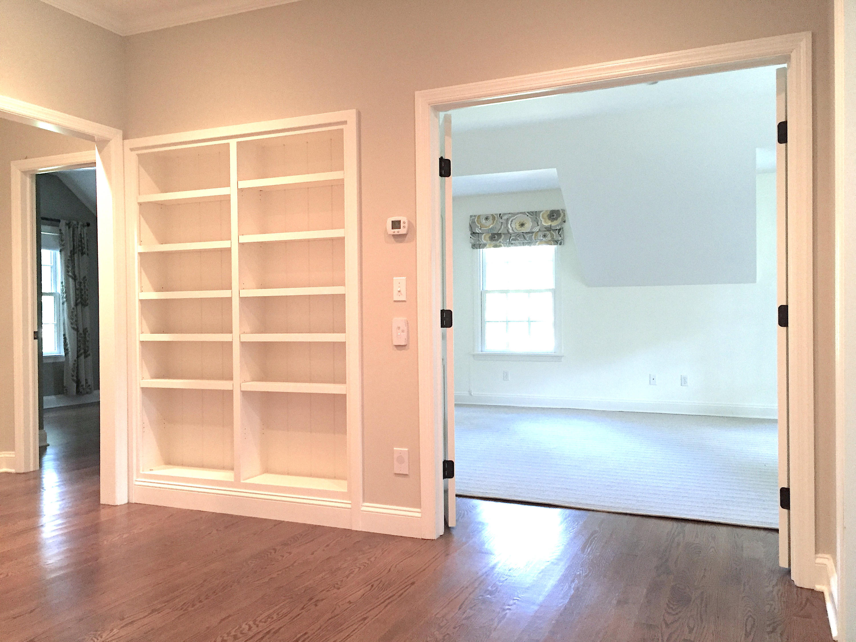181 Middlesex Road Darien, CT 06820 - Photo 32 of 38 an empty room with wooden floor and cabinet