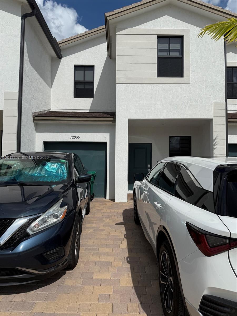 12955 Southwest 231st Terrace, Unit 12955 Miami, FL 33170 - Photo 1 of 26 a view of a car park in front of the house