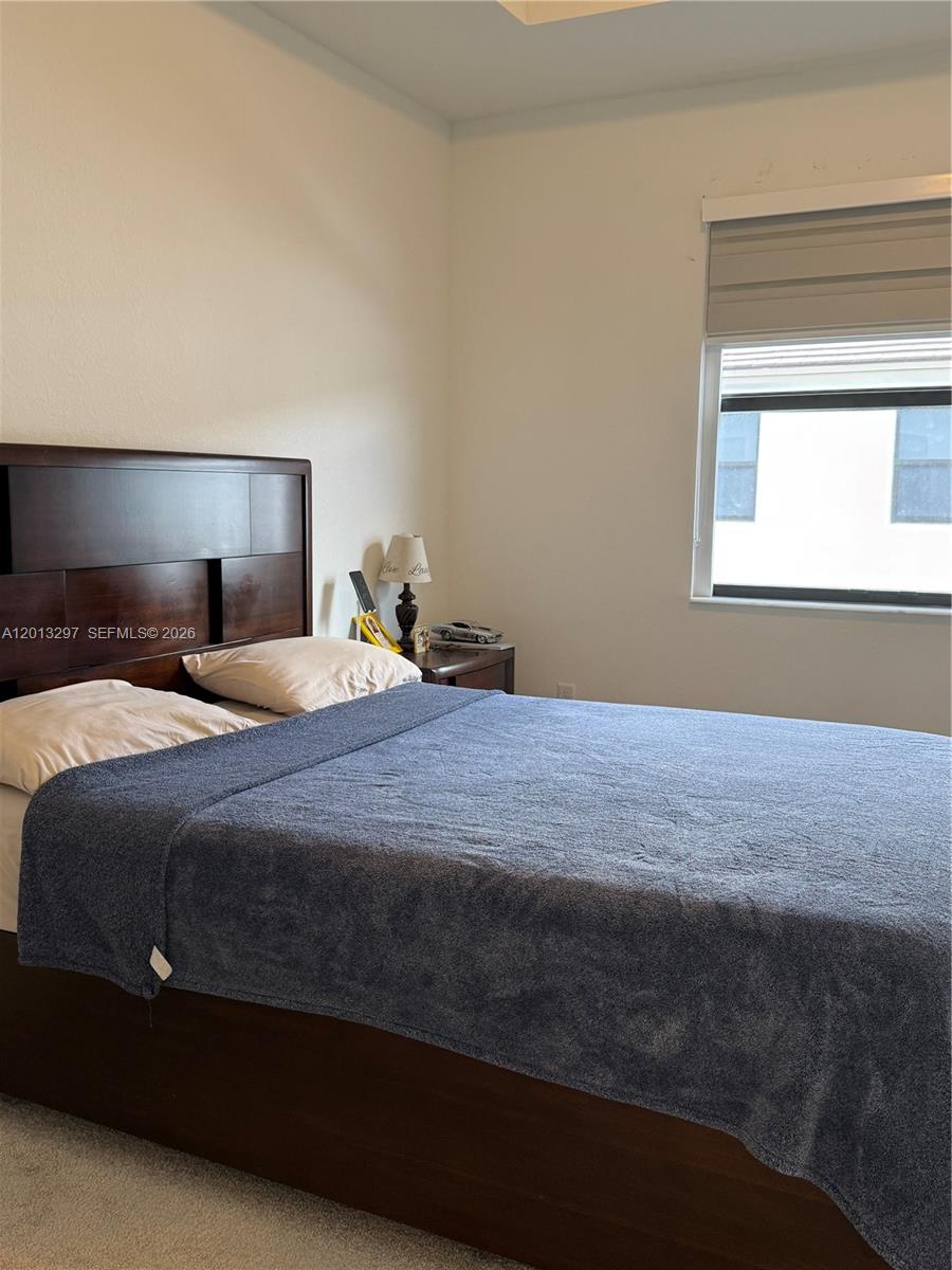 12955 Southwest 231st Terrace, Unit 12955 Miami, FL 33170 - Photo 11 of 26 a bedroom with a bed and a window