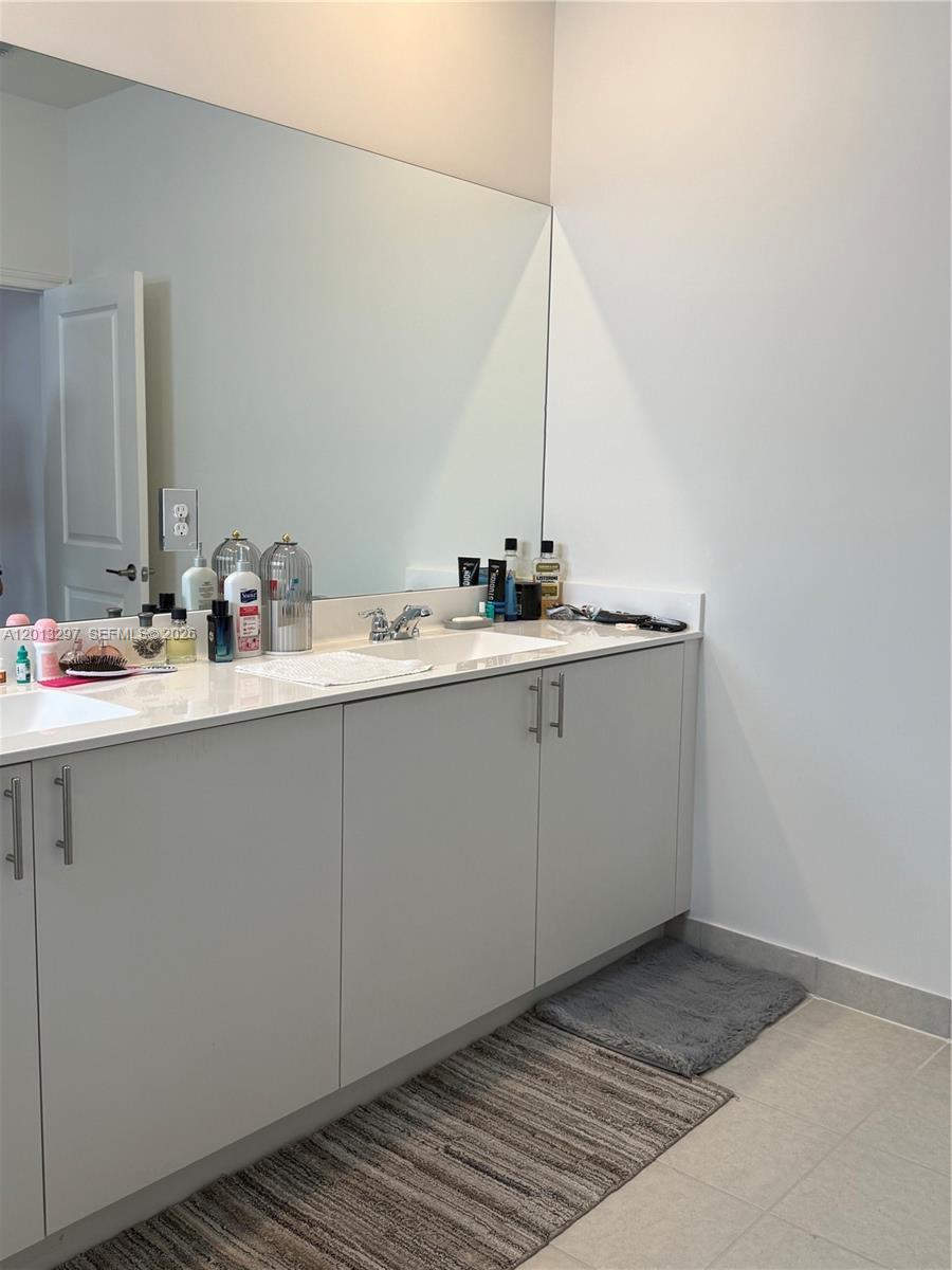 12955 Southwest 231st Terrace, Unit 12955 Miami, FL 33170 - Photo 14 of 26 a bathroom with a sink and a mirror