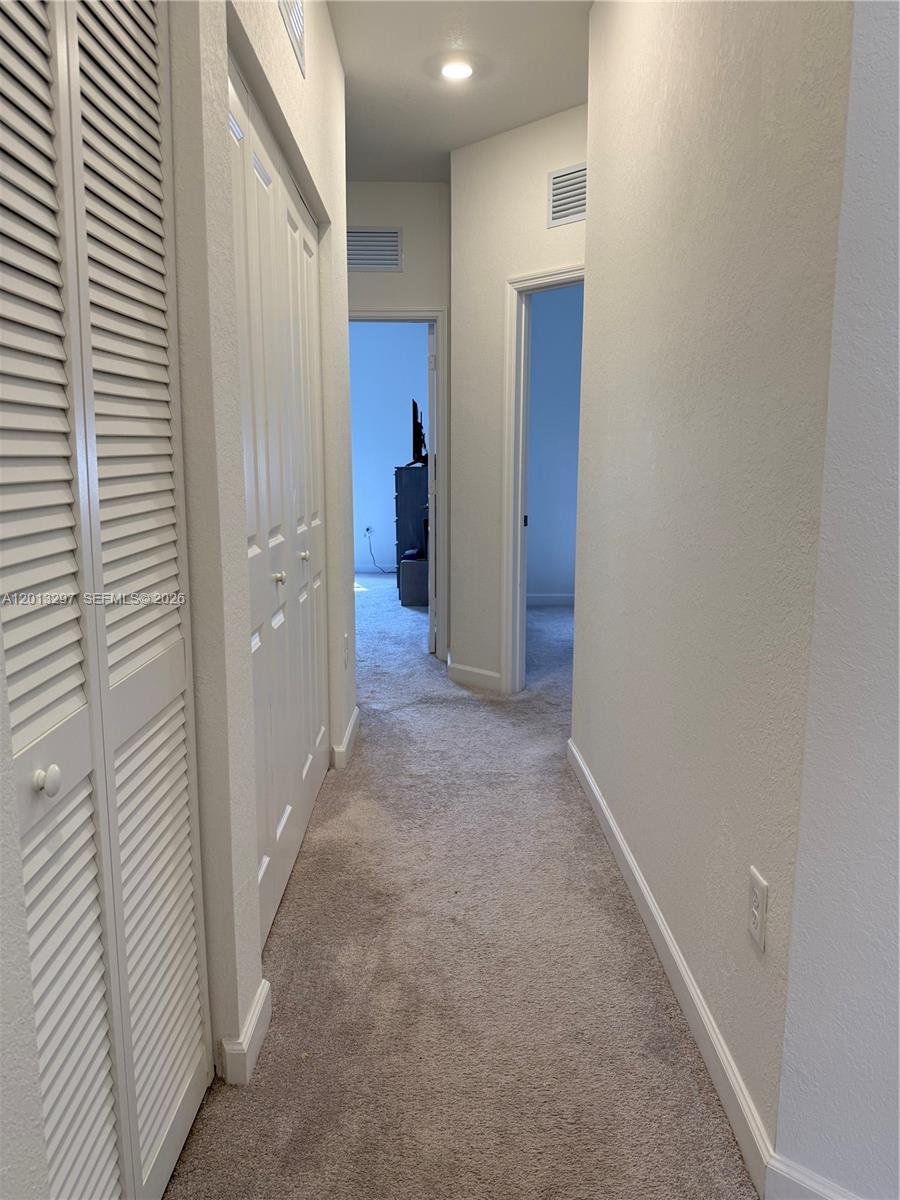 12955 Southwest 231st Terrace, Unit 12955 Miami, FL 33170 - Photo 17 of 26 a view of a hallway with closet and bathroom
