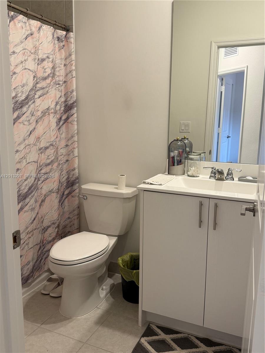 12955 Southwest 231st Terrace, Unit 12955 Miami, FL 33170 - Photo 23 of 26 a bathroom with a sink toilet and mirror