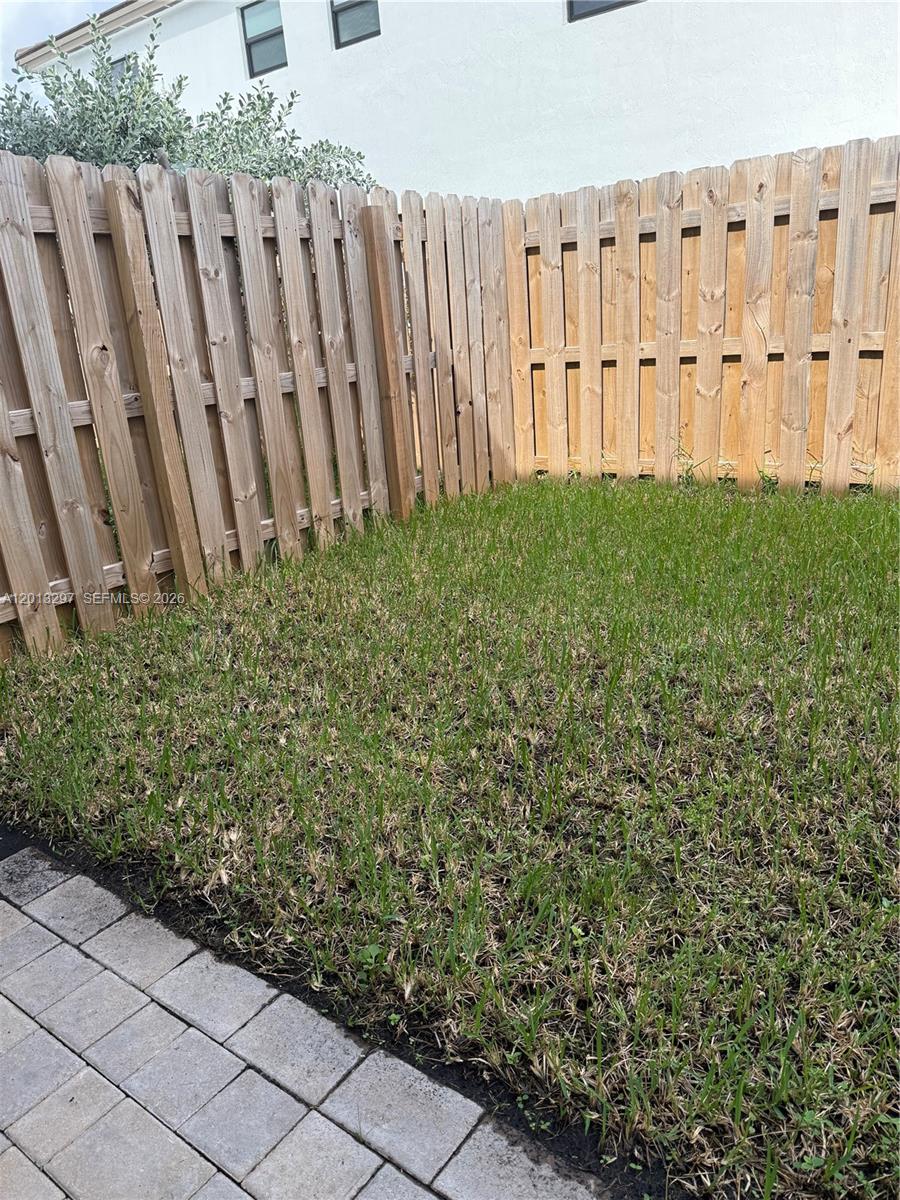 12955 Southwest 231st Terrace, Unit 12955 Miami, FL 33170 - Photo 25 of 26 a view of a backyard with white fence